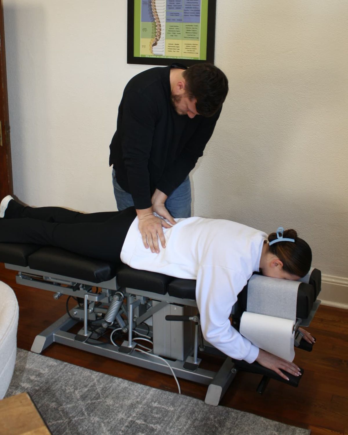 Dr. Scrimo delivering a lumbar adjustment in the Roswell treatment room