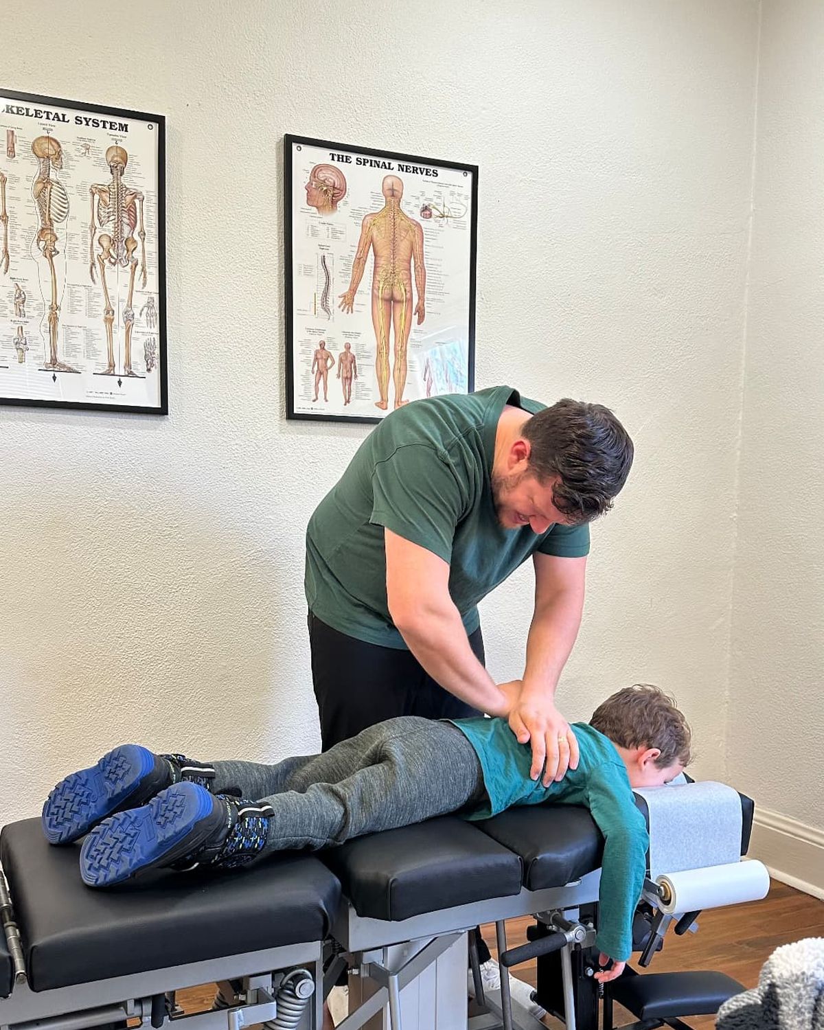 Dr. Scrimo performing a gentle pediatric adjustment on a young patient